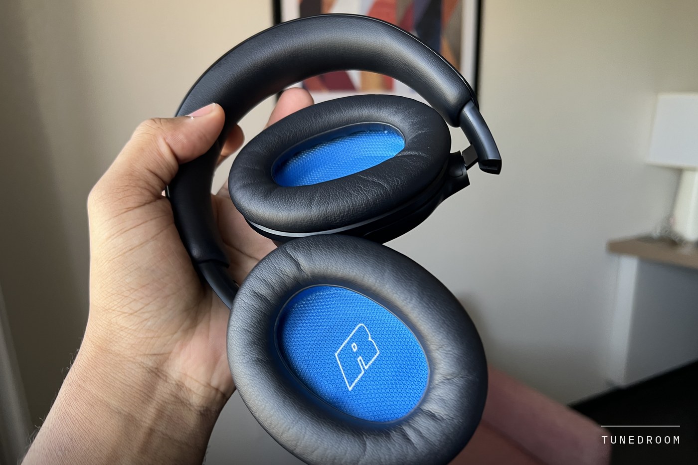 Both earcups held up to show the oval cushions and the blue interior lining