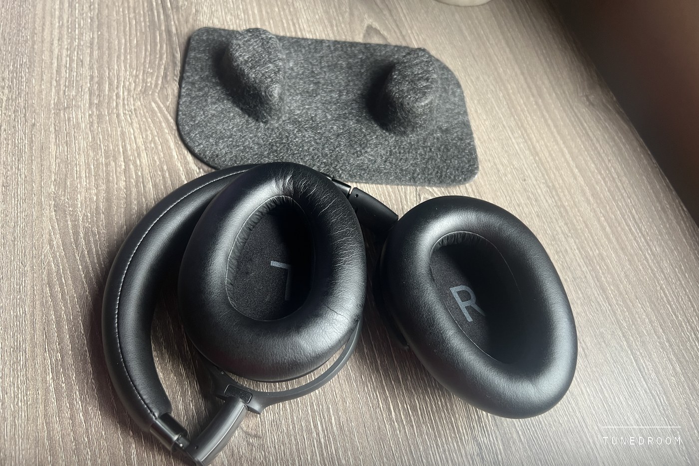 The Adapt 660 folded with its two leatherette ear pads facing up, an R printed inside the right cup