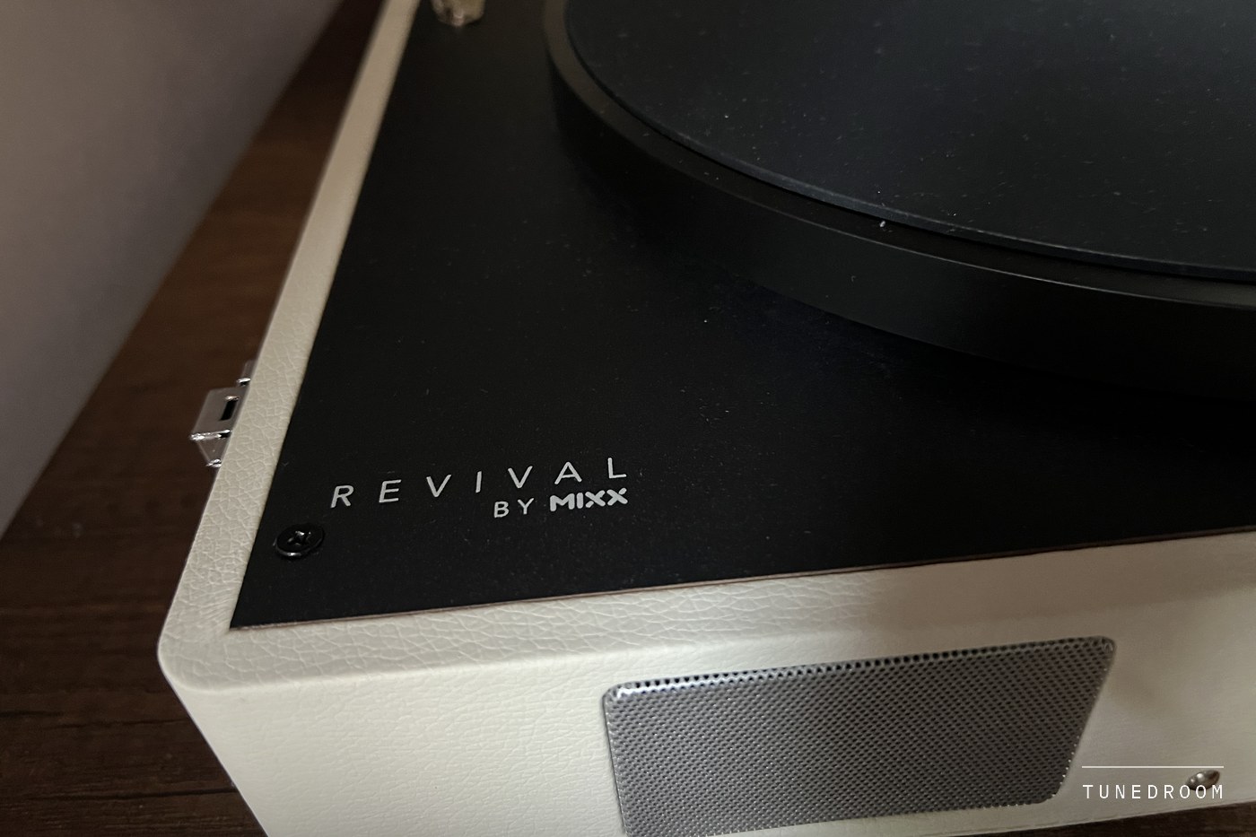 A front corner of the Revival 65, the REVIVAL BY MIXX wordmark on the black deck above one perforated speaker grille