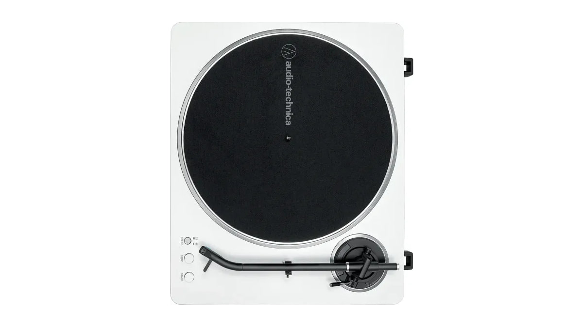 White/Silver Audio-Technica AT-LP70X turntable viewed from above, with a black felt mat on the platter and a black J-shaped tonearm.