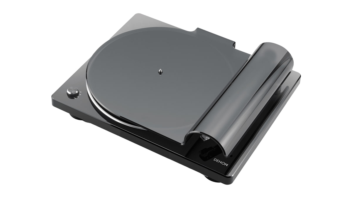 Black Denon turntable viewed from above at an angle with its fitted translucent dust cover.