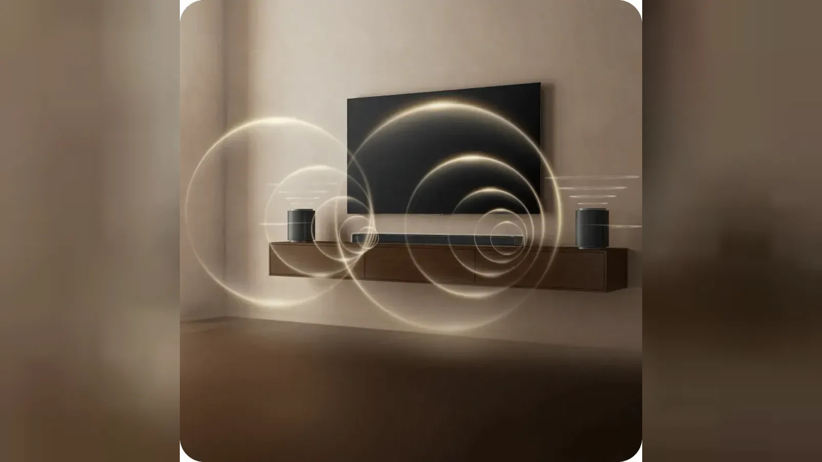 A soundbar and two speakers sit beneath a wall mounted TV, with glowing rings illustrating sound.